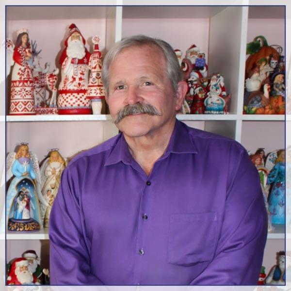 Jim Shore in front of figurines