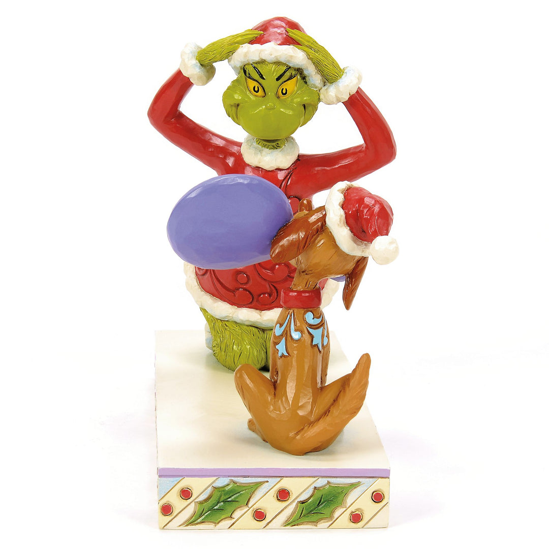 Max Holding a Mirror for the Grinch Figurine